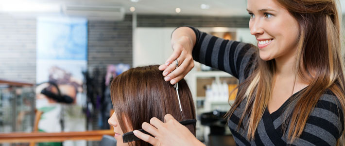 Woman hairdresser cutting hair